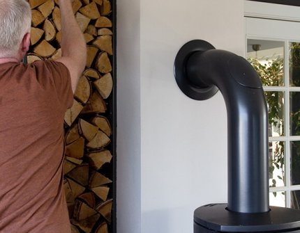 Man tar ved att sätta i den öppna spisen